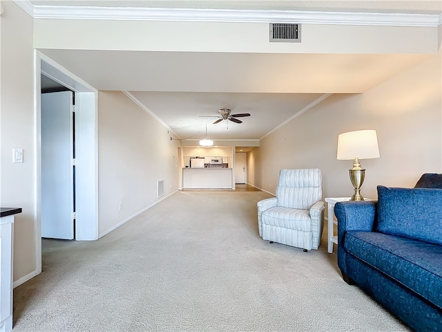 unfurnished living room featuring carpet flooring, ceiling fan, and crown molding