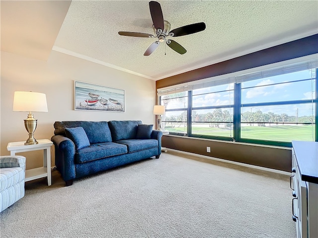 carpeted living room featuring ceiling fan, crown molding, and a textured ceiling