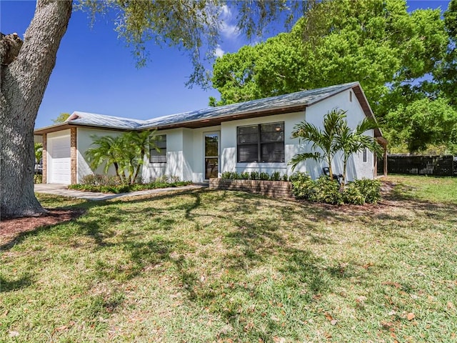 ranch-style house with a garage, a front yard, and fence