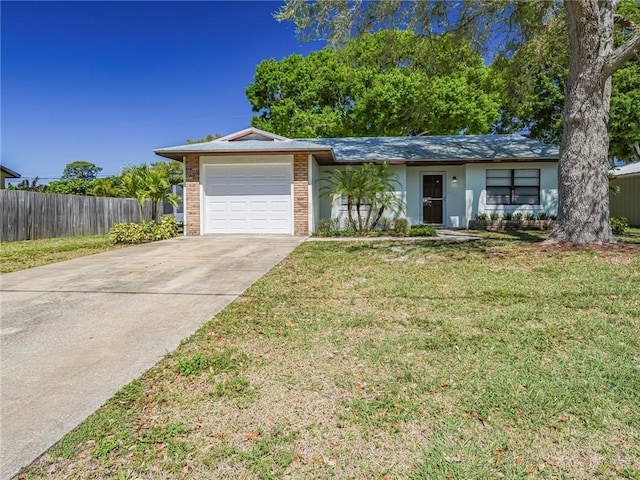 view of front of property with a garage, brick siding, fence, driveway, and a front lawn