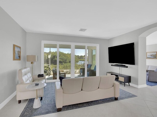 5235 W Harbor Village Dr, Vero Beach, FL 32967 - tiled living room featuring arched walkways, visible vents, and baseboards