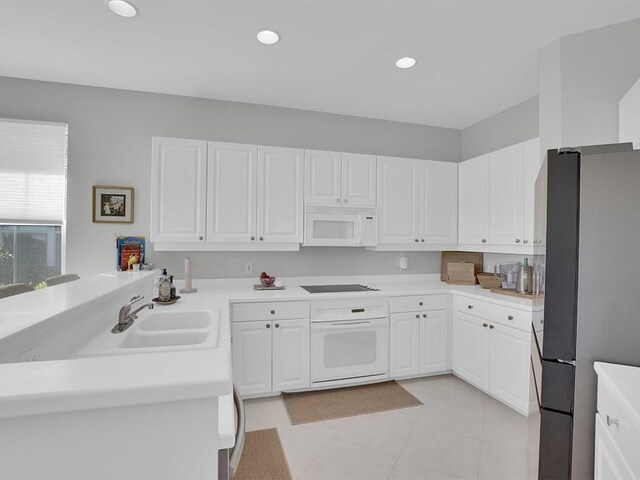 5235 W Harbor Village Dr, Vero Beach, FL 32967 - kitchen featuring recessed lighting, white appliances, white cabinetry, and a sink