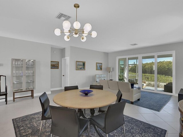 5235 W Harbor Village Dr, Vero Beach, FL 32967 - dining area with a chandelier, visible vents, tile patterned flooring, and baseboards