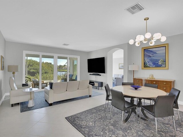 5235 W Harbor Village Dr, Vero Beach, FL 32967 - dining room with visible vents, arched walkways, tile patterned flooring, baseboards, and a chandelier