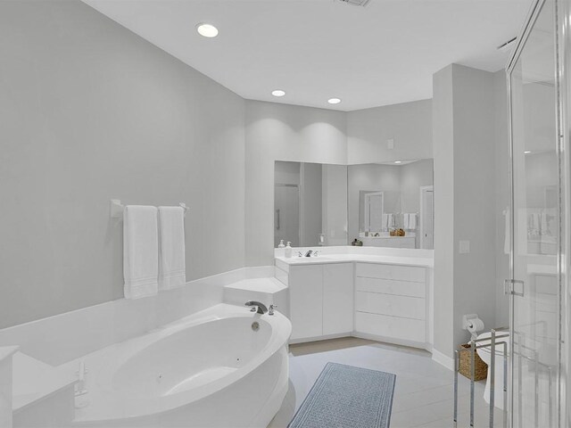 5235 W Harbor Village Dr, Vero Beach, FL 32967 - full bathroom with recessed lighting, a tub with jets, a stall shower, and vanity