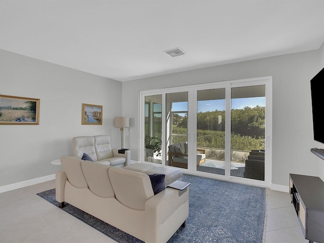 5235 W Harbor Village Dr, Vero Beach, FL 32967 - living room featuring light tile patterned floors, visible vents, and baseboards