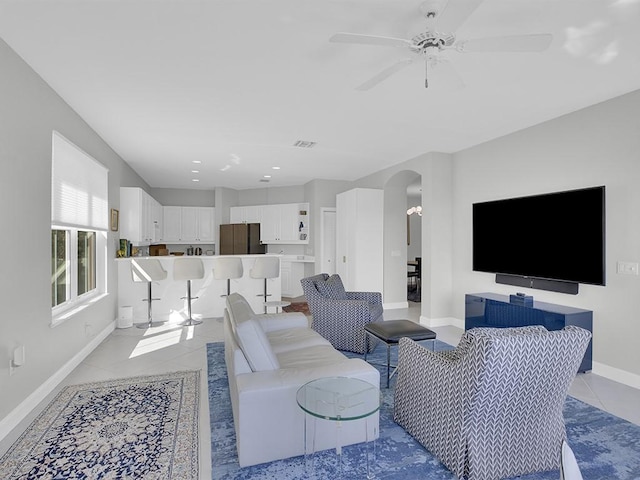5235 W Harbor Village Dr, Vero Beach, FL 32967 - living room with visible vents, ceiling fan, baseboards, light tile patterned floors, and arched walkways