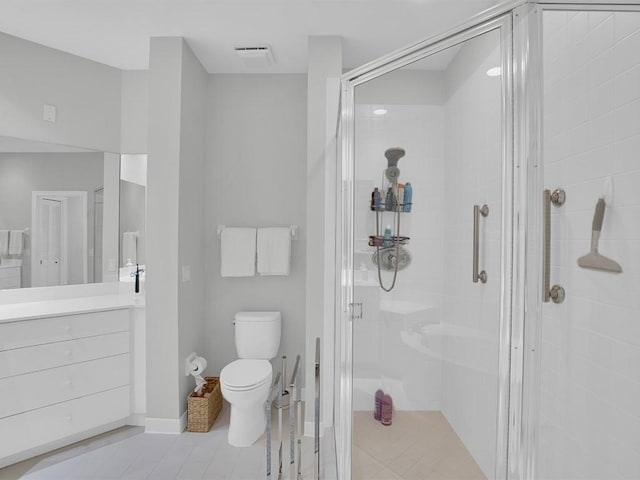 5235 W Harbor Village Dr, Vero Beach, FL 32967 - bathroom with vanity, visible vents, a stall shower, tile patterned floors, and toilet