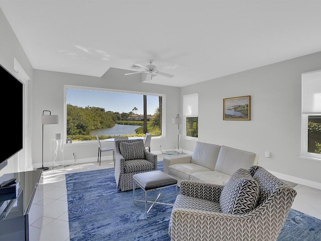 5235 W Harbor Village Dr, Vero Beach, FL 32967 - living area featuring ceiling fan, baseboards, a water view, and light tile patterned flooring