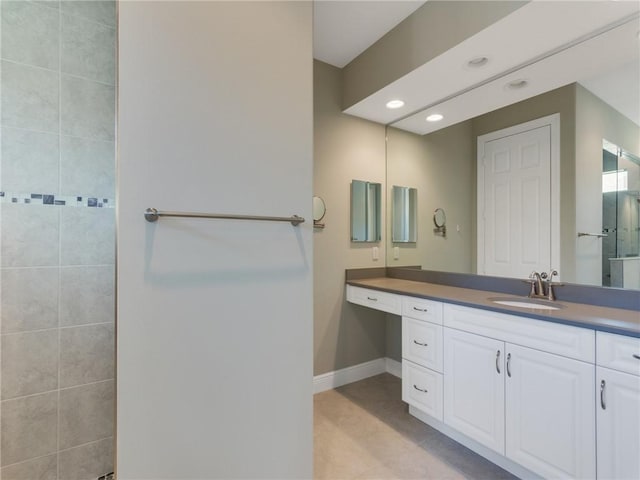 bathroom featuring tile patterned flooring and vanity