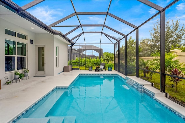 view of swimming pool with a lanai, a patio area, and pool water feature