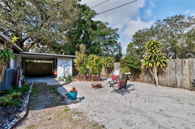 view of yard featuring an outdoor fire pit and central air condition unit