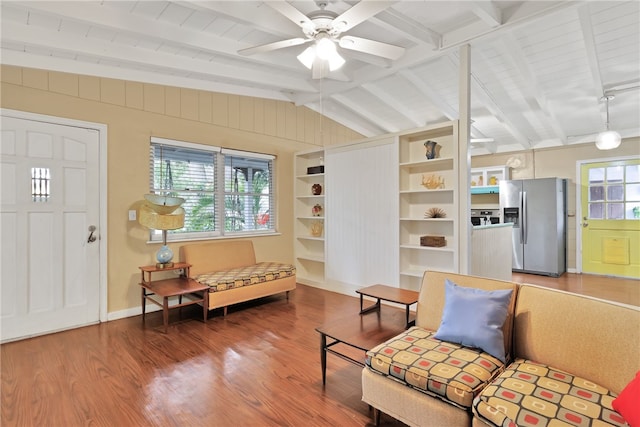 interior space featuring ceiling fan, wood-type flooring, and lofted ceiling with beams