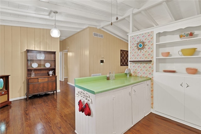 kitchen with hanging light fixtures, dark wood-type flooring, vaulted ceiling with beams, and white cabinets