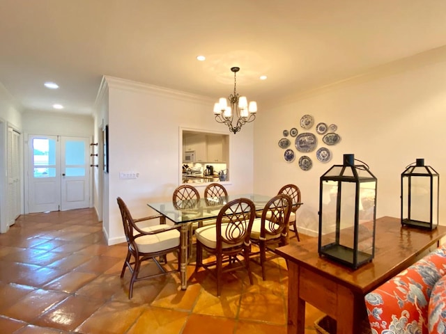 tiled dining room with french doors, crown molding, and a chandelier