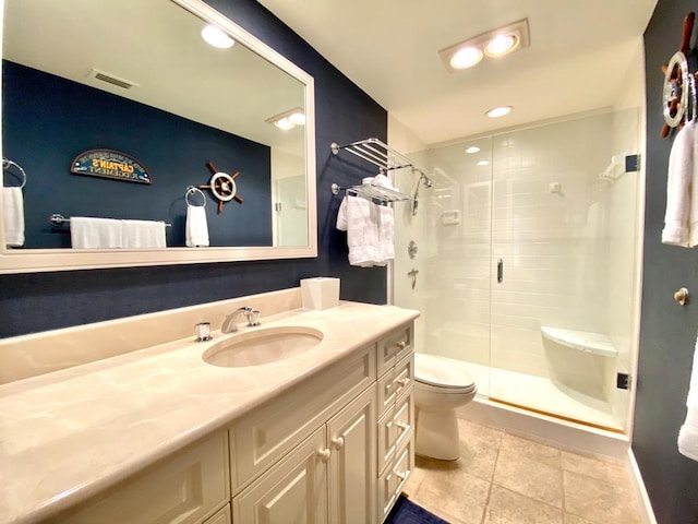 bathroom with tile patterned flooring, vanity, toilet, and walk in shower