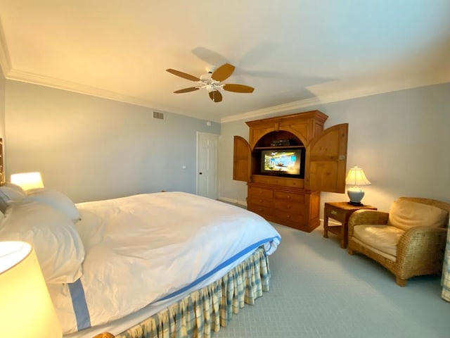 bedroom featuring ceiling fan, crown molding, and carpet floors