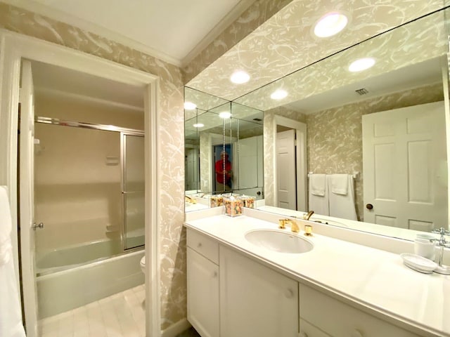 full bathroom with vanity, toilet, and enclosed tub / shower combo