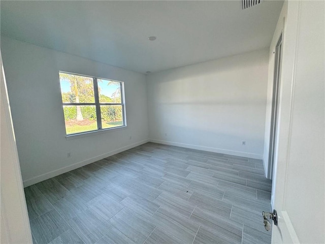 unfurnished room with visible vents and baseboards