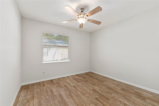 empty room featuring ceiling fan, a textured ceiling, and light wood-type flooring