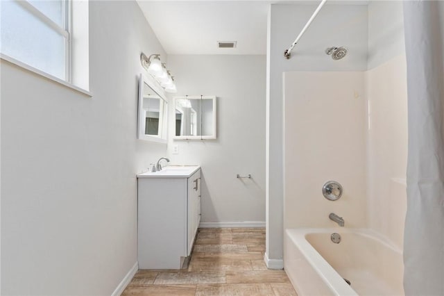 bathroom with vanity,  shower combination, and hardwood / wood-style flooring