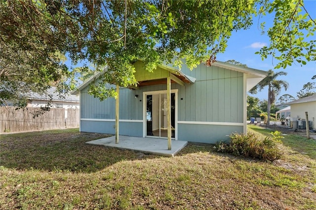 rear view of property with a yard