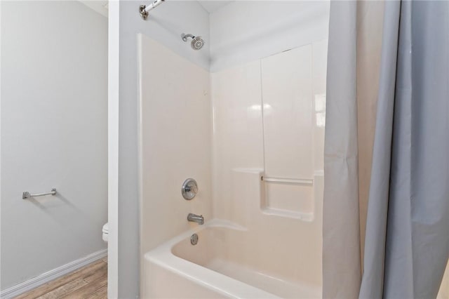 bathroom with shower / bath combination with curtain, toilet, and wood-type flooring