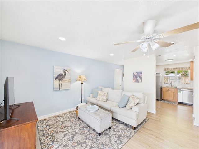2297 Whiteside Ave SE, Palm Bay, FL 32909 - living area featuring a ceiling fan, baseboards, recessed lighting, and light wood-style flooring