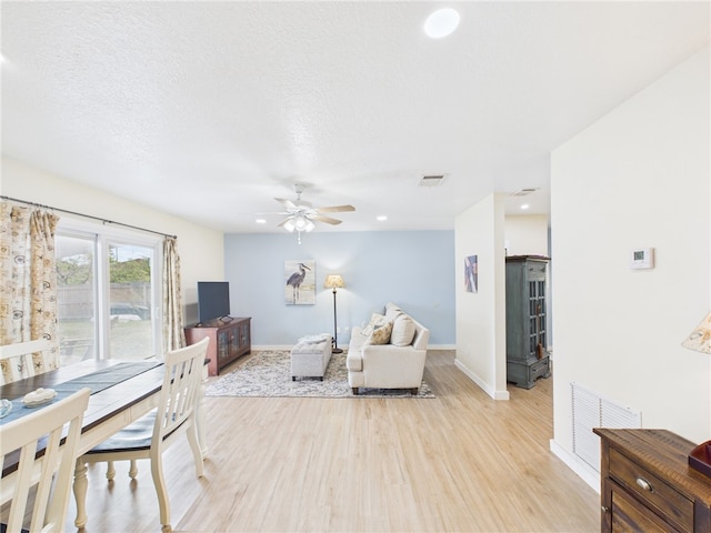 2297 Whiteside Ave SE, Palm Bay, FL 32909 - living room with a ceiling fan, baseboards, visible vents, and light wood finished floors
