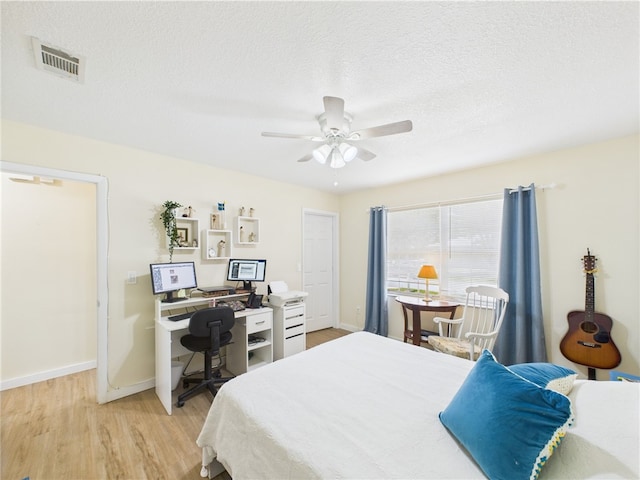 2297 Whiteside Ave SE, Palm Bay, FL 32909 - bedroom with visible vents, a textured ceiling, light wood-style flooring, and baseboards