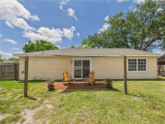 2297 Whiteside Ave SE, Palm Bay, FL 32909 - rear view of property featuring fence, a lawn, and a patio area