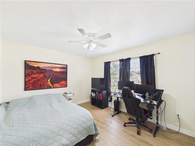 2297 Whiteside Ave SE, Palm Bay, FL 32909 - bedroom with a textured ceiling, baseboards, a ceiling fan, and wood finished floors