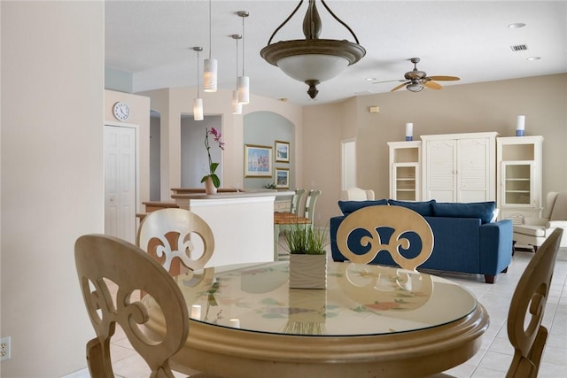 tiled dining area featuring ceiling fan