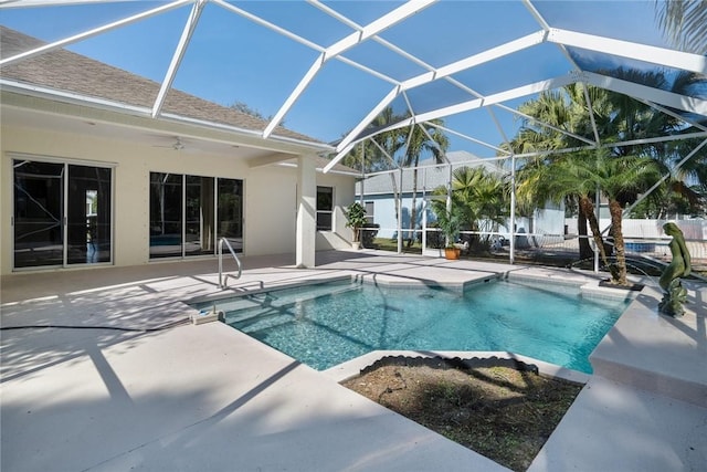 view of pool with a lanai, ceiling fan, and a patio area