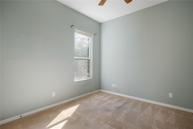 carpeted spare room with ceiling fan