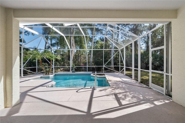 view of swimming pool featuring a patio and glass enclosure