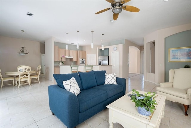 living room featuring ceiling fan and light tile patterned flooring