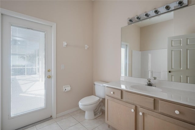 bathroom with walk in shower, vanity, toilet, and tile patterned flooring