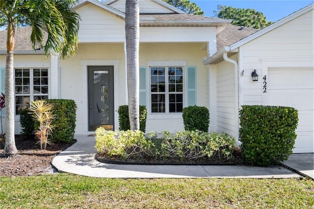 doorway to property with a garage