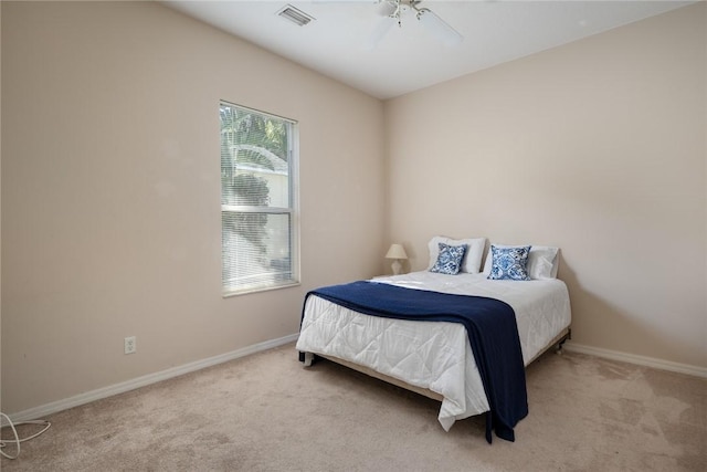 bedroom with light carpet and ceiling fan