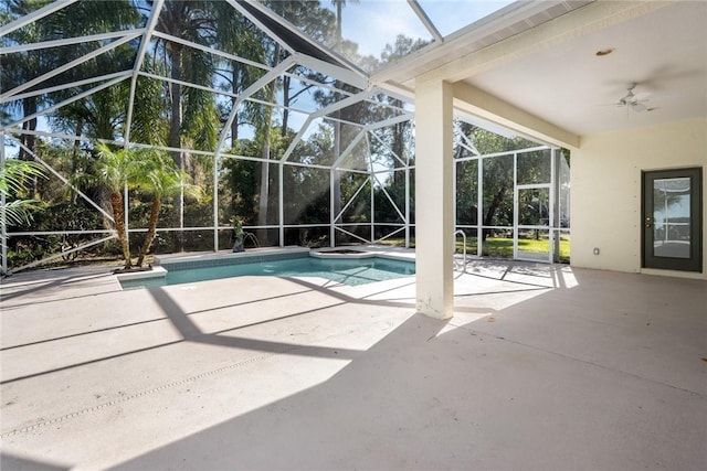 view of swimming pool with a patio, ceiling fan, and glass enclosure