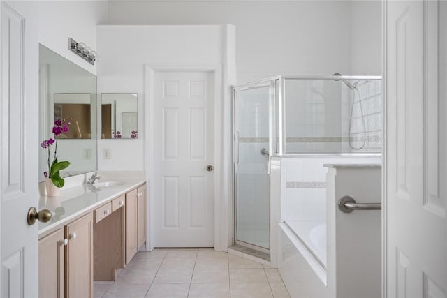 bathroom featuring shower with separate bathtub, tile patterned floors, and vanity