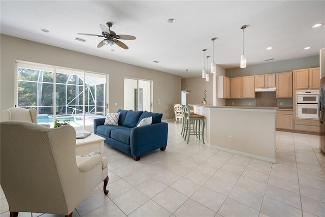 tiled living room with ceiling fan