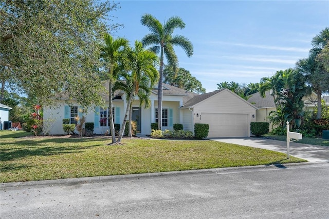 view of front of property with a garage and a front lawn