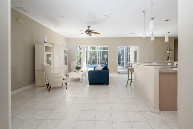 living room featuring light tile patterned floors and ceiling fan