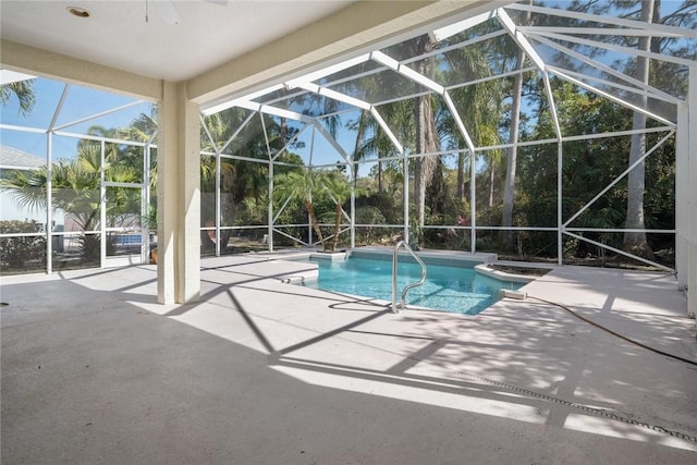 view of swimming pool with a patio and glass enclosure