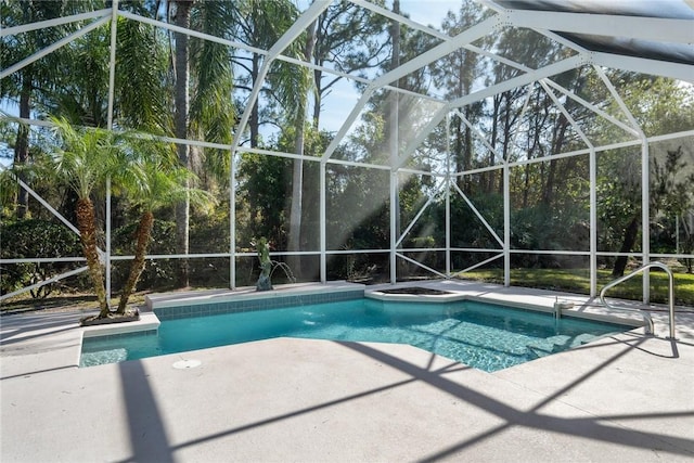 view of pool with a hot tub, a lanai, and a patio area