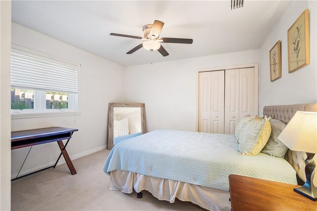 carpeted bedroom featuring ceiling fan and a closet