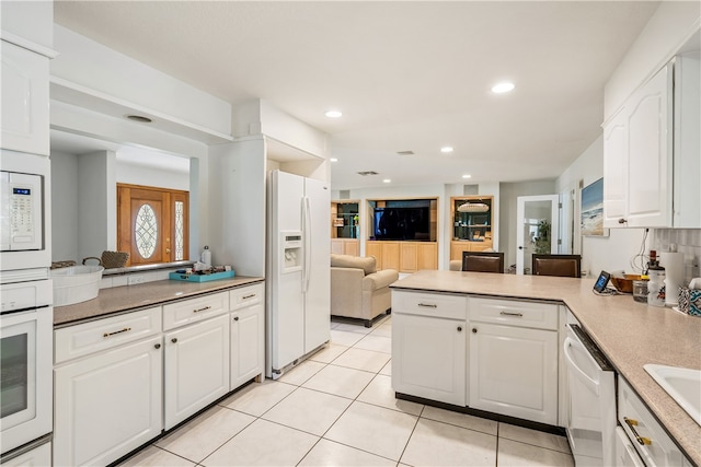 kitchen with white cabinetry, kitchen peninsula, light tile patterned floors, backsplash, and white appliances