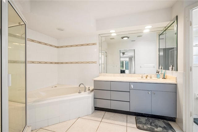 bathroom featuring vanity, tile patterned flooring, and shower with separate bathtub